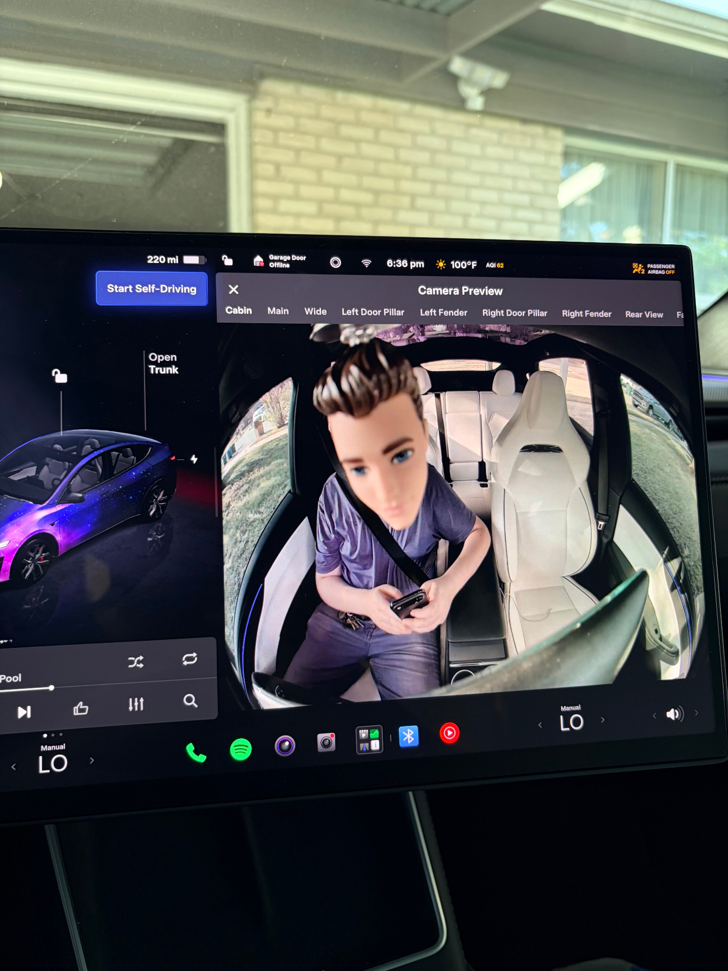 Tesla cabin camera preview showing the FSD Buddy bobblehead mounted in front of the driver monitoring camera